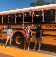 Teachers waving outside a schoolbus!